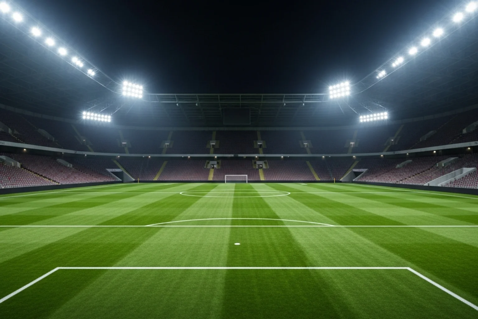 Fussballstadion bei Flutlicht mit Blick auf das Spielfeld